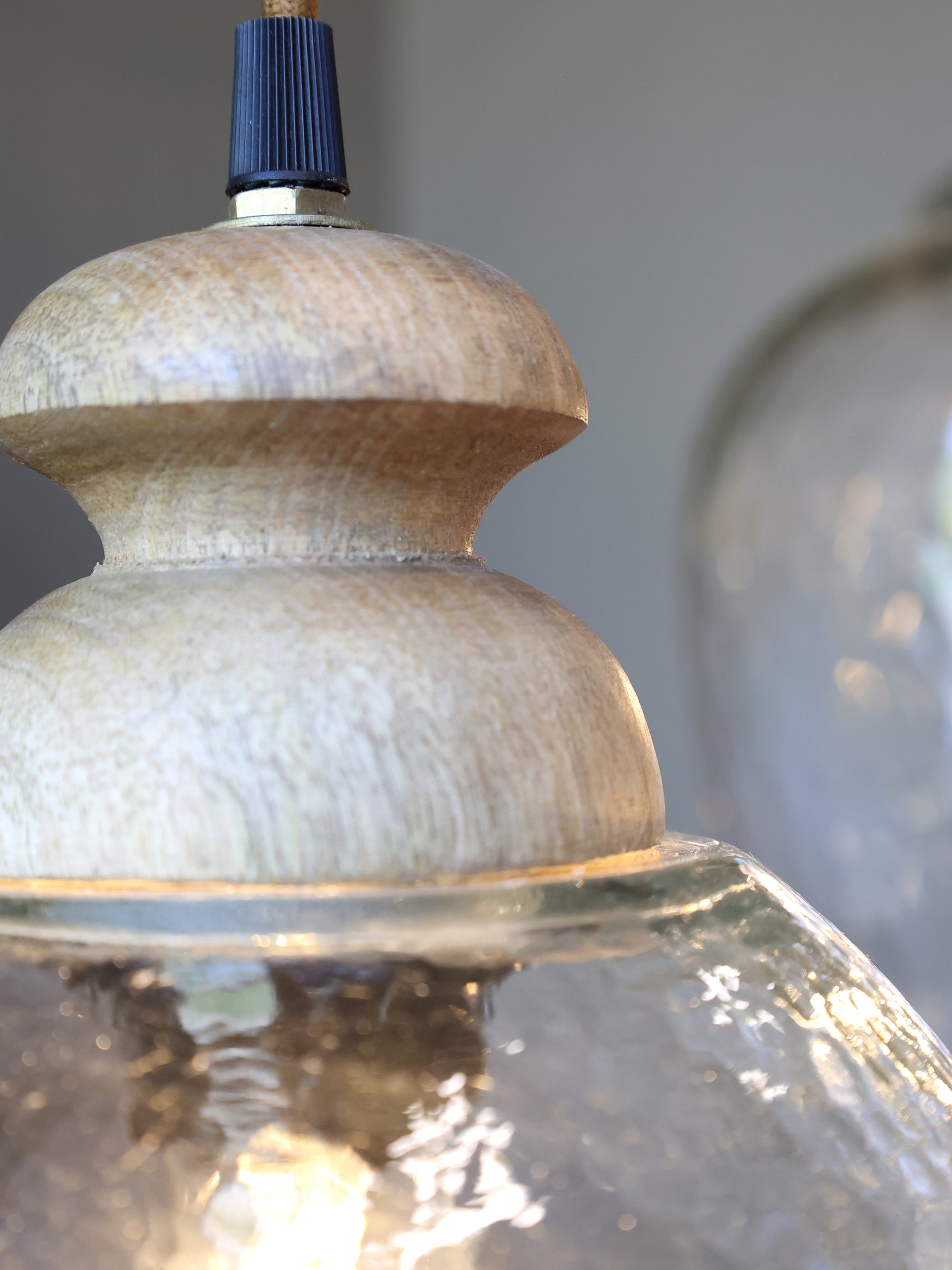 hammered glass pendant light close-up to see wood detail