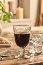 hand-blown goblet style wine glass displayed on a wooden dining table