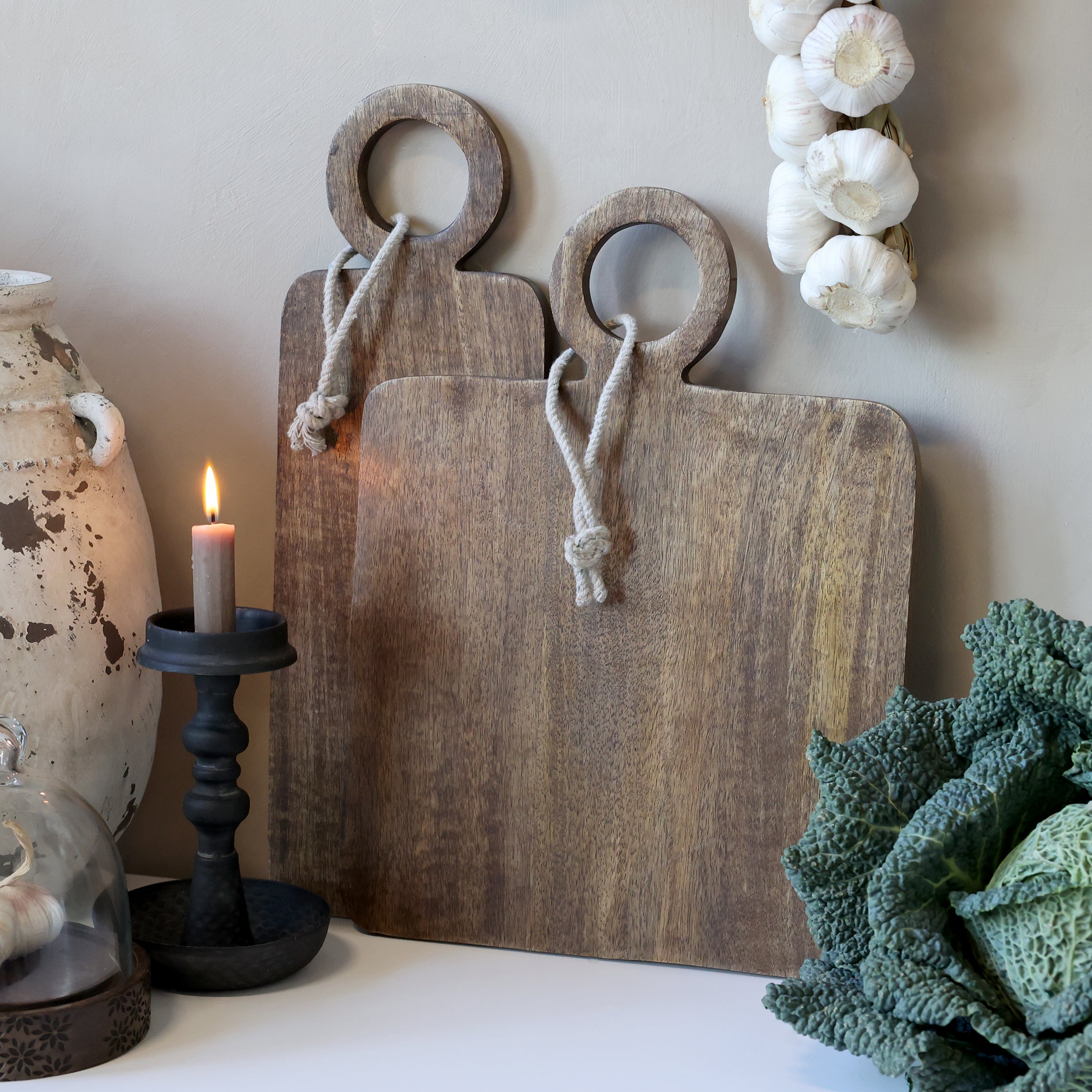 square wooden serving board with round handles and made with Mango wood